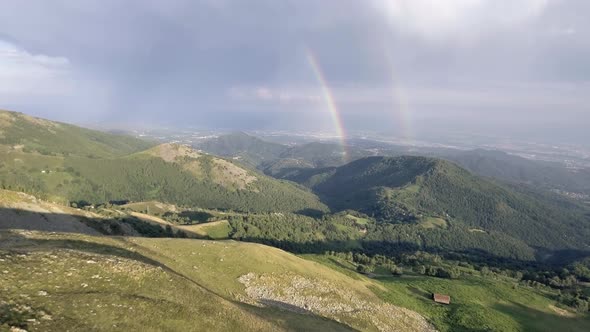 Mountain Summer Sunny Sunset or Sunrise Dawn or Dusk with Lodge and Rainbow Nature Establishing Shot alt