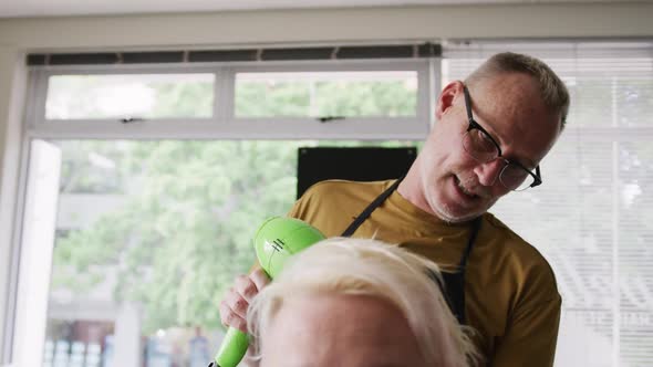 Front view woman having her hair dry by a hairdresser alt