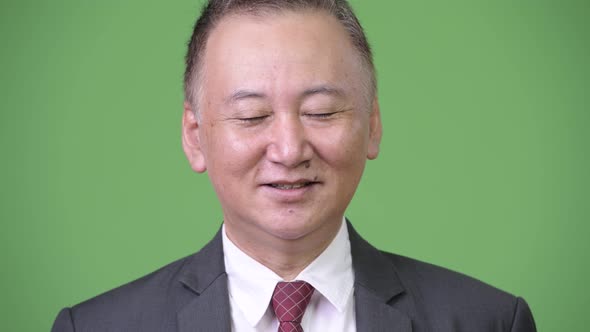 Mature Japanese Businessman Relaxing alt
