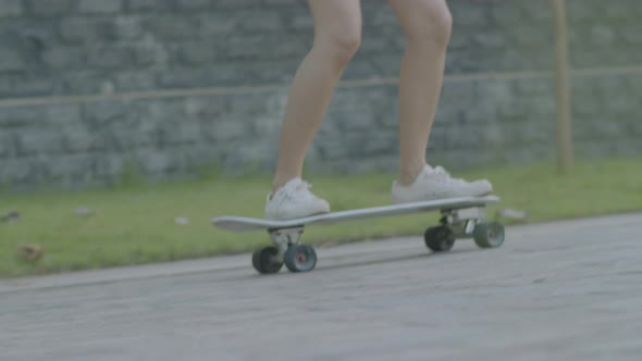 legs Asian women hipster playing surf skate feels happy to enjoy surfing skate.