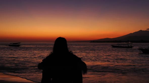 One woman tanning on tranquil resort beach voyage by blue water with white sand background of the Ma alt