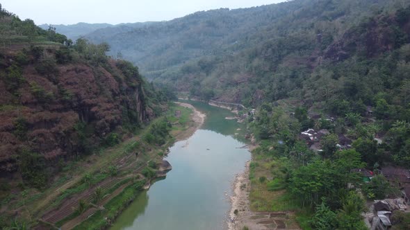 Beautiful aerial view of a river in the middle of the mountains in the morning alt