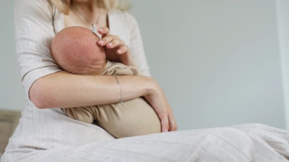 close-up woman breastfeeding her baby alt