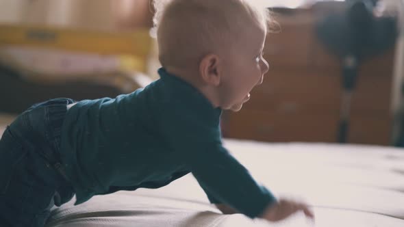 Cute Baby Crawls to Elder Sister Kicking Piggybank on Bed alt