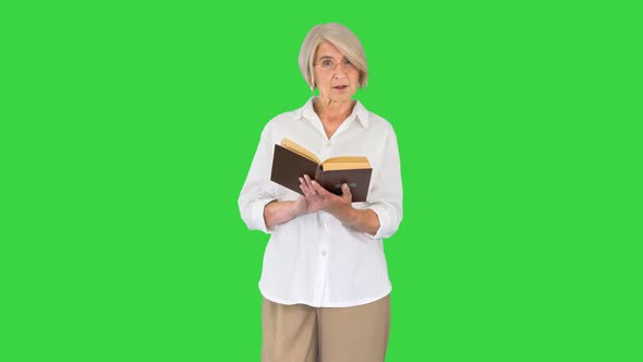 Senior Lady Woman Reading Old Book Out Loud on a Green Screen Chroma Key alt