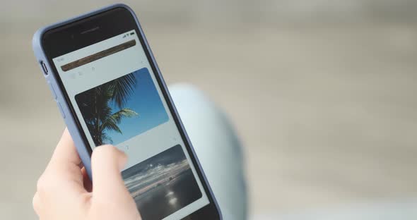 Young Woman Using Smartphone Scrolling Through Social Network Feed Doing Swiping alt