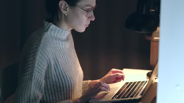 Female tired working on a laptop. alt