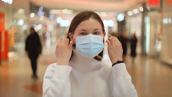 Woman Takes Off Protective Mask From Virus in Shopping Mall Smiling