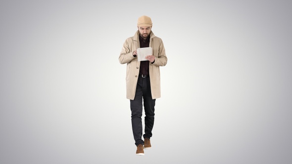 Stylish guy connected on internet with tablet on gradient alt