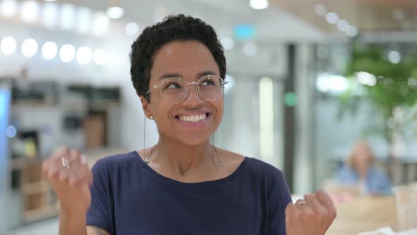 Portrait of Casual African Woman Celebrating Success, Winning  alt