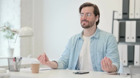 Young Man Meditating Music Smartphone alt