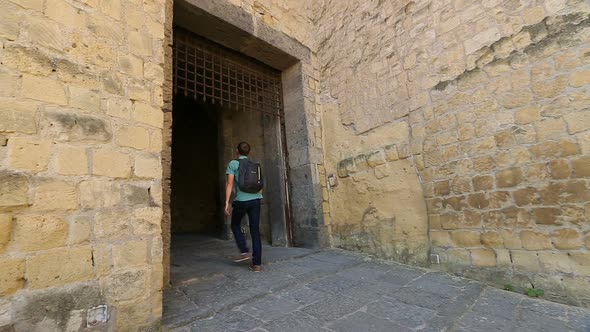 Male Tourist Entering Medieval Castel Dell'Ovo, Sightseeing in Naples, Tourism alt