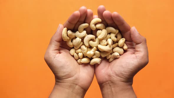 Top View of Cashew Nut on Palm of Hand alt
