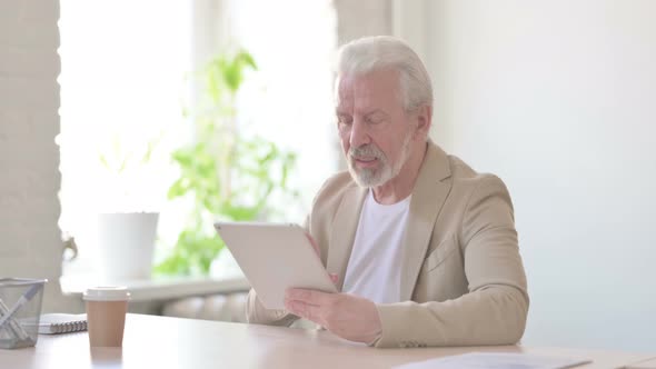 Online Video Chat on Tablet By Old Man in Office alt