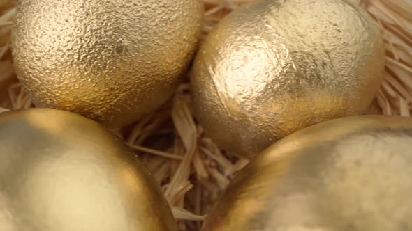 Easter Eggs Painted in Gold Color on Blue Wooden Table Close Up