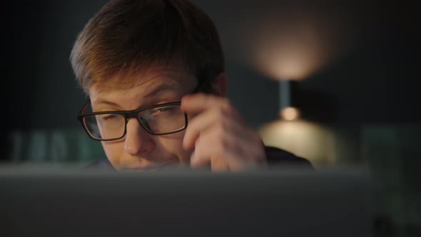 Man in Glasses with a Laptop Eyes Tired Took Off Glasses Rubbed Eyes