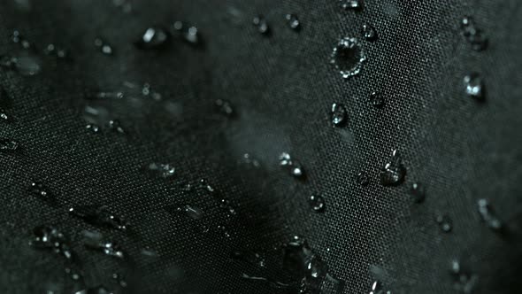 Super Slow Motion Shot of Water Splashing on Waterproof Cloth at 1000Fps alt