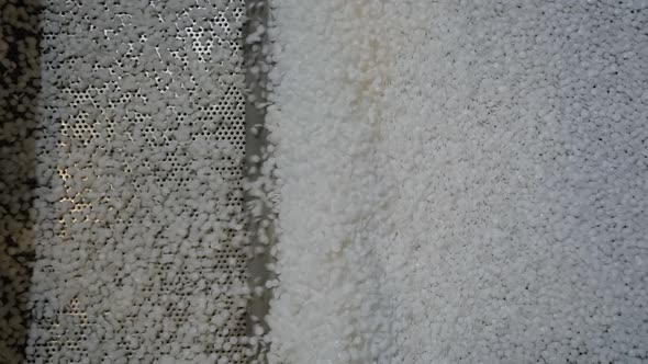 Close Up Recycled Plastic Granules on Automatic Shale Shaker Conveyor Belt