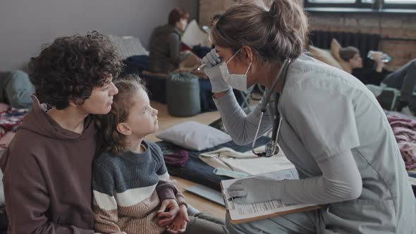 Nurse Examining Child in Refuge alt