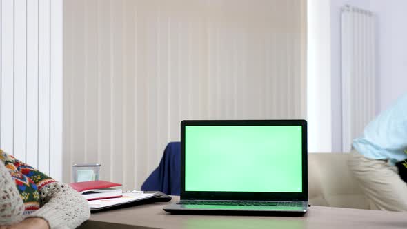 Computer with a Green Screen on the Desk in Living Room alt