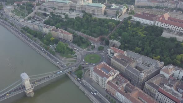 Aerial view of roundabout city traffic near Szechenyi Chain Bridge Cars go on circle road Budapest