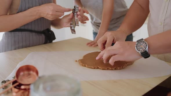 Boy with Parents are Cutting Biscuits Out of Dough and Placing on Oven Tray