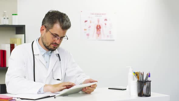 Doctor Working on Tablet at Hospital alt