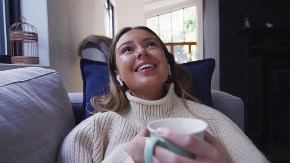 Portrait of woman waving while drinking coffee alt