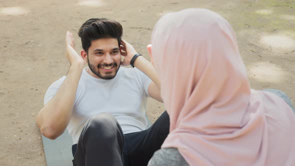 Muscular Hindu Guy Training Abdominal Muscles on Yoga Mat with Help of Woman in alt