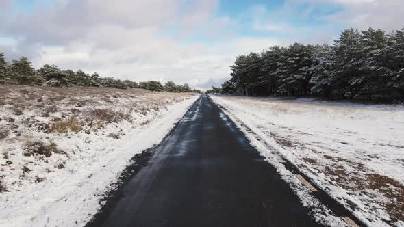 Car Driving on Snow-covered Snowy Mountain Road in Winter Snow. Drivers Point of View. alt