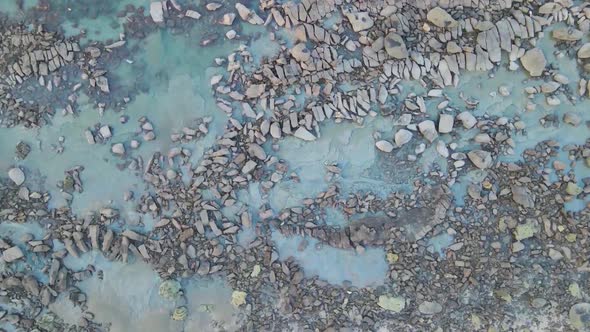 Tilt down aerial view of rocky surface - Big stones, environment, geology, stony planet concept alt