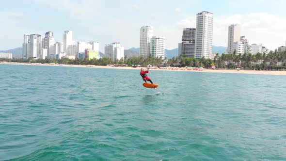 Acrobatic Jump of Professional Kite Surfer on the Sea Wave, Athlete Showing Sport Trick Jumping alt