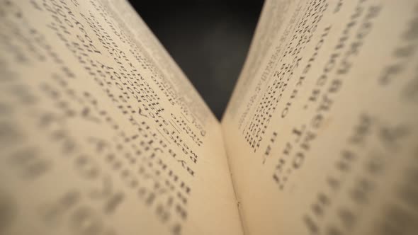 Camera Moves Inside the Book. Old Book Sways in the Wind. Slider Shot with Probe Lens. UHD,  alt