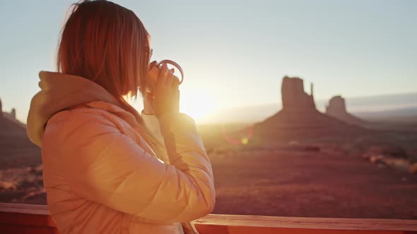 Scenic Sunrise in Monument Valley Woman Enjoying Peaceful Morning with Coffee alt