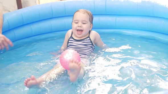 A Girl in an Inflatable Pool