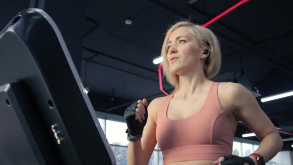 Young woman training on treadmill