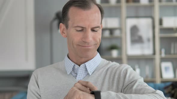 Middle Aged Man Using Smartwatch alt