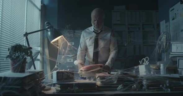 Businessman searching for files in his abandoned office
