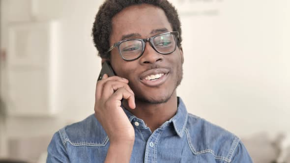 African Man Talking on Phone alt