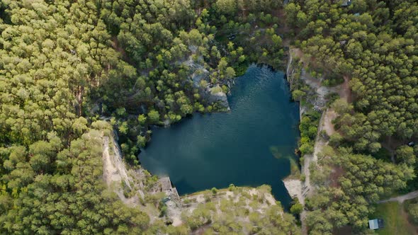 Aerial view of blue teal lake and green Crystal clear mountain lake water surface alt