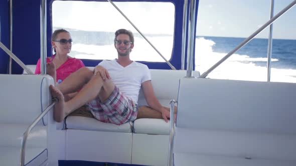 Young Couple Sitting Close in Speed Boat