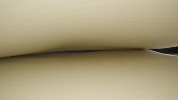 White Lined Pages of Notebook Against Black Wall in Studio