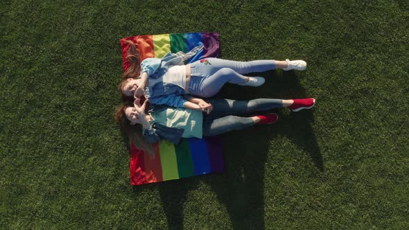 Drone Shot of Lgbt Couple Lying on Rainbow Flag, Stock Footage | VideoHive