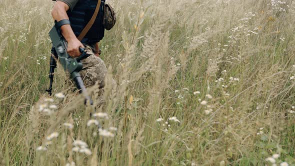 Using a Mine Detector Minesweeper Using a Mine Detonator Outdoors Soldier Removing Mines Sapper alt