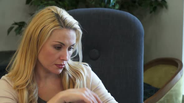 Sad Woman Looks at a Photo and Misses Someone alt