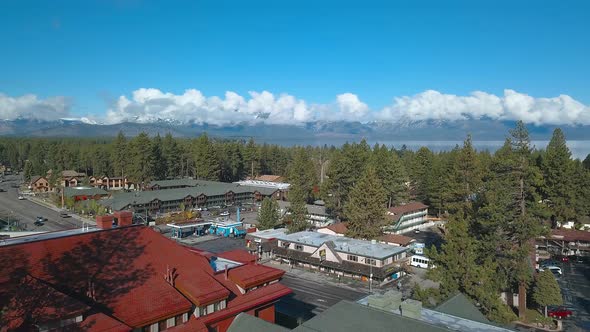 Drone footage of South Lake Tahoe and snow capped mountains in the background. 4K alt