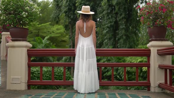 Female Dressed in White Dress, Stands at the Terrasse, She Looks To the Woods alt