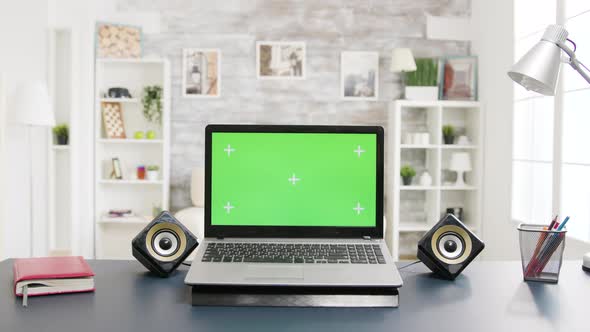 Green Screen Laptop on the Table in Room with Nobody in It alt