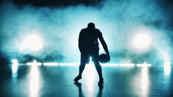 Male Player is Dribbling a Basketball in Dark alt