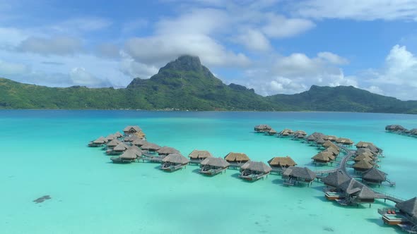 Aerial drone view of a luxury resort and overwater bungalows in Bora Bora tropical island. alt